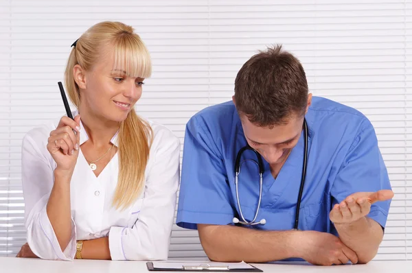 Doctor and nurse at table — Stock Photo, Image