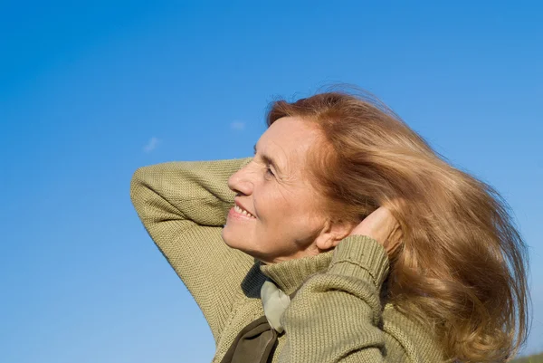 Elderly woman and sky — Stock Photo, Image