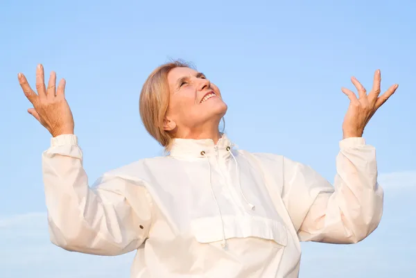 Happy old woman at sky — Stock Photo, Image