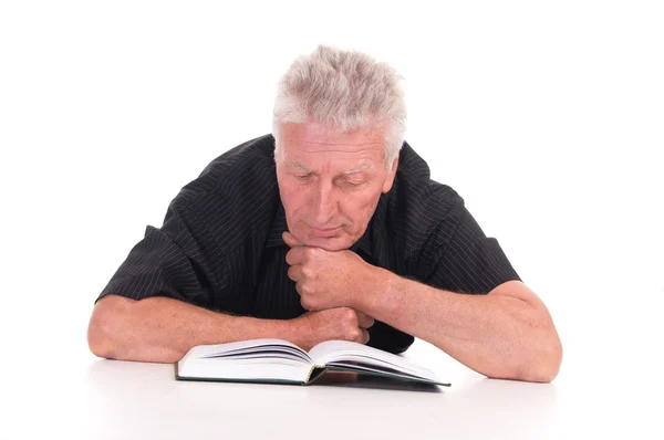 Aged man lying with book — Stock Photo, Image