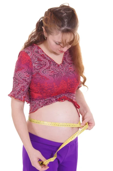 Těhotná žena s měřítkem — Stock fotografie