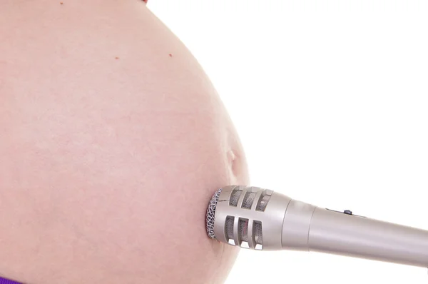 Pregnant belly and microphone — Stockfoto