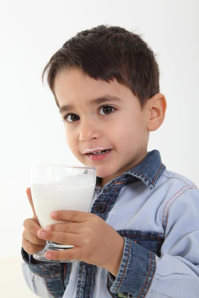 Child drinking glass of milk — Stock Photo, Image