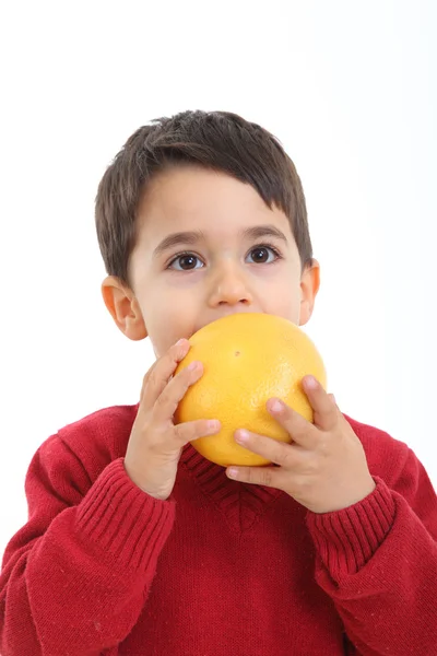 Adorable child with a grapefruit — Stock Photo, Image