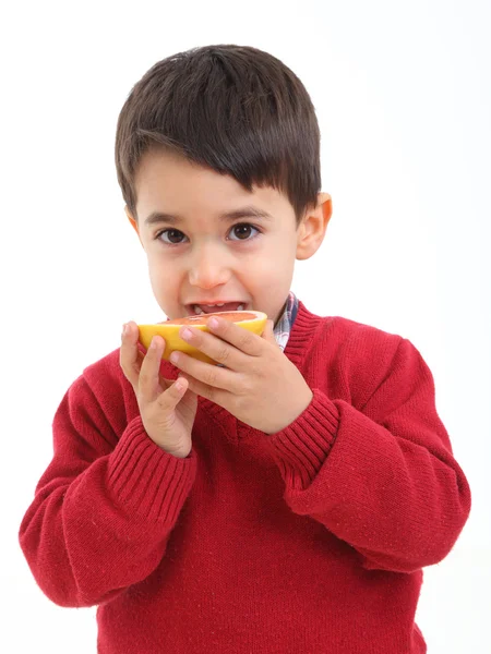 Adorable child with a grapefruit — Stock Photo, Image