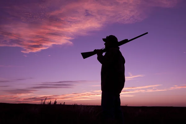 Ορεινών κυνηγός με κυνηγετικό όπλο στο ηλιοβασίλεμα — Φωτογραφία Αρχείου