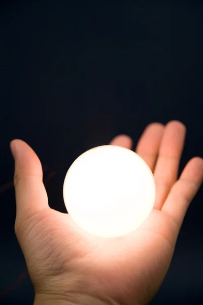 Ruka držící světlé koule — Stock fotografie