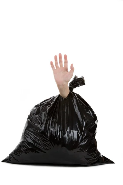 Мешок для мусора и рука — стоковое фото