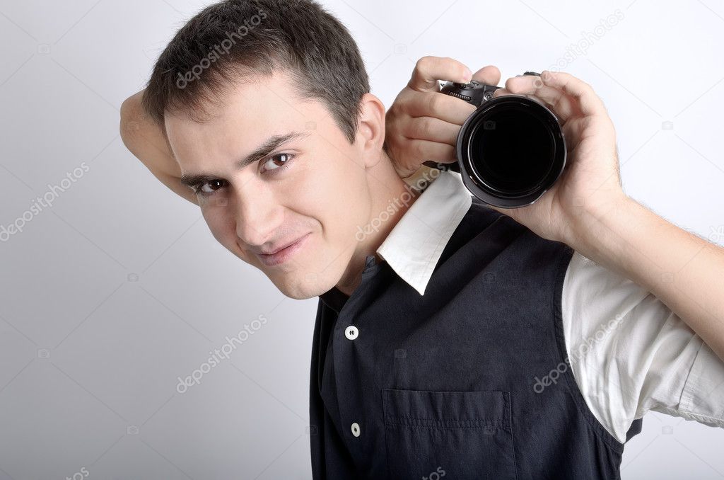 Attractive photographer (paparazzi) with digital camera.