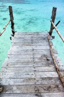 Pier over crystal clear water clipart