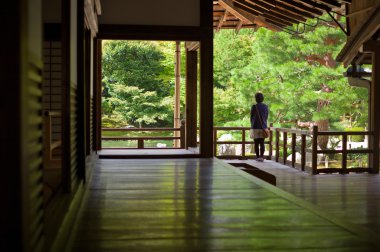 Young girl looking to japanese zen garden clipart