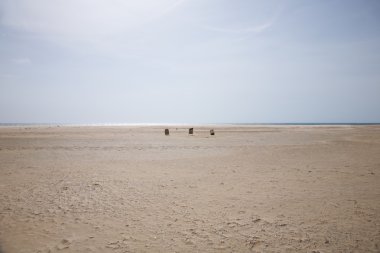 Three dustbins at the beach clipart