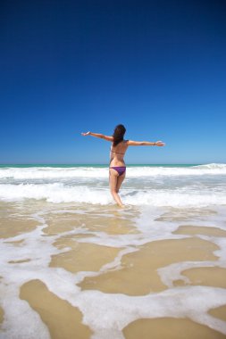 Woman running to the ocean clipart