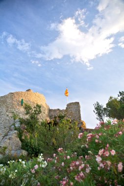 Flag on Begur castle ruins clipart