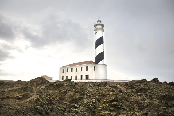 Favaritx lighthouse on rock cape — Stock Photo, Image