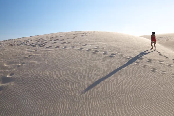 Woman and shadow up the dune — Stock Photo, Image