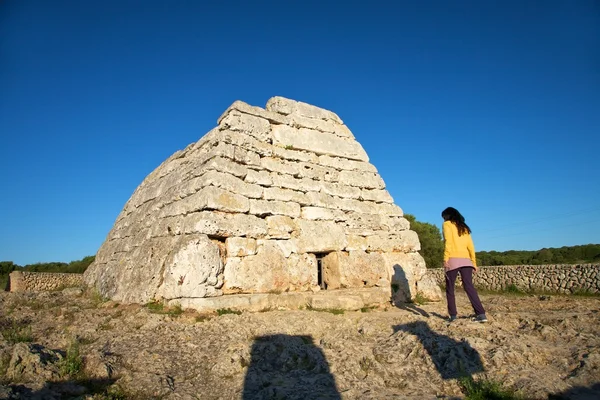 Woman walking in front of prehistoric monument — Stock Photo, Image