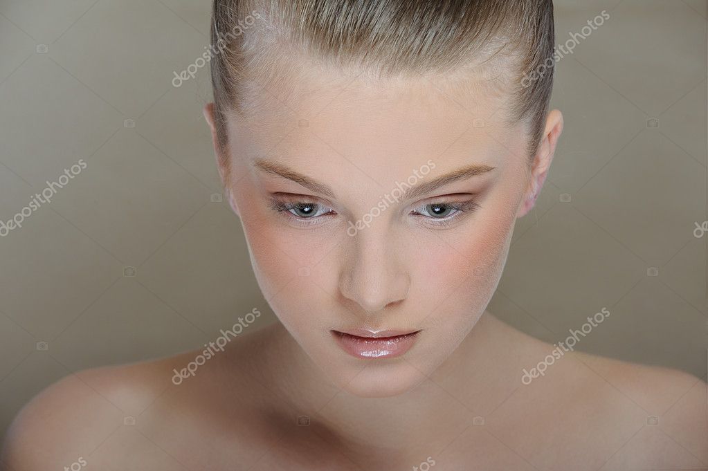 Beautiful young girl with health skin of face and delicate makeup look