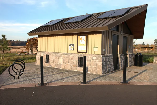 stock image Solar panels on a park restroom facility.