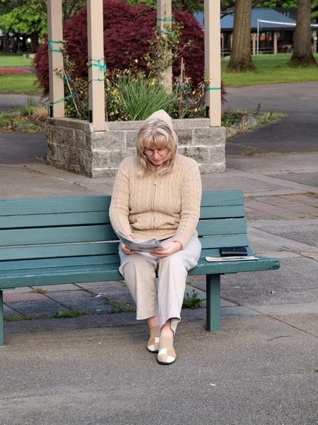 stock image Reading outdoors in a park.