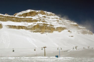 The chairlift and the Dolomites - Folgarida clipart