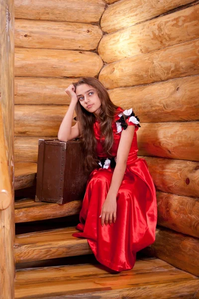 Girl in red spanish dress sitting on stairs — Stock Photo, Image