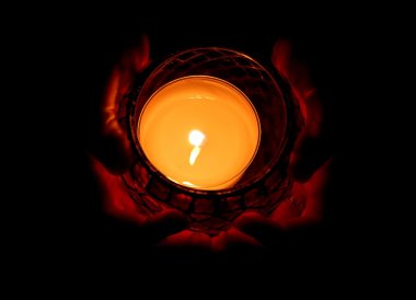 Burning candle in hand clipart