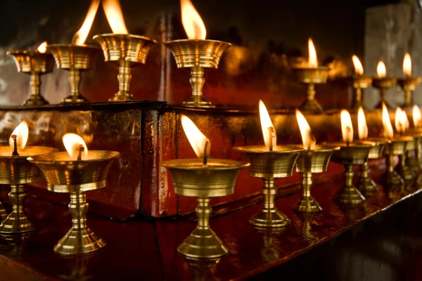 Some rows of candles in Tibetan temple — Stock Photo, Image