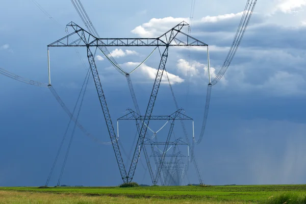 Electric high voltage pylon against dramatic sky — Stock Photo, Image