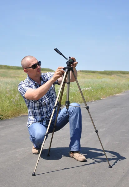 stock image Young man with tripod