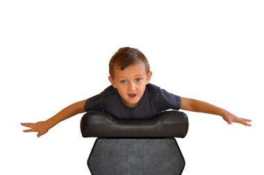 A boy lies on a soft black stools clipart