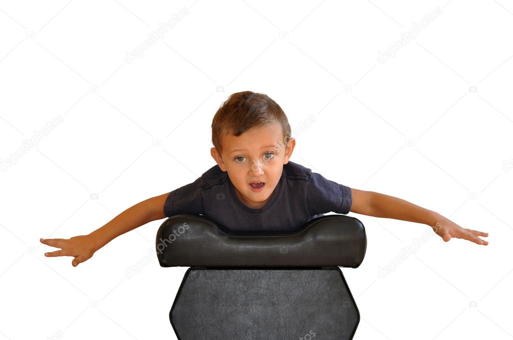A boy lies on a soft black stools