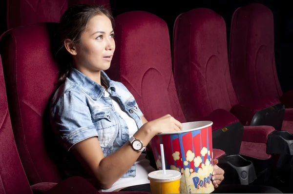 女子看电影时吃爆米花 — 图库照片