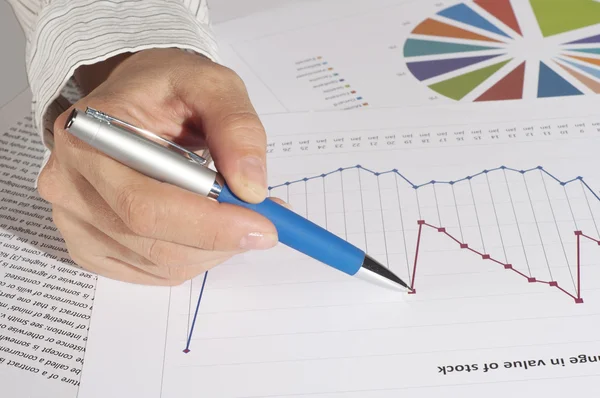 stock image Hand with the handle specifies charts of growth