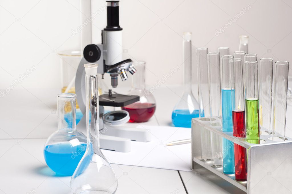 Lab flasks, tubes, microscope, lab workplace