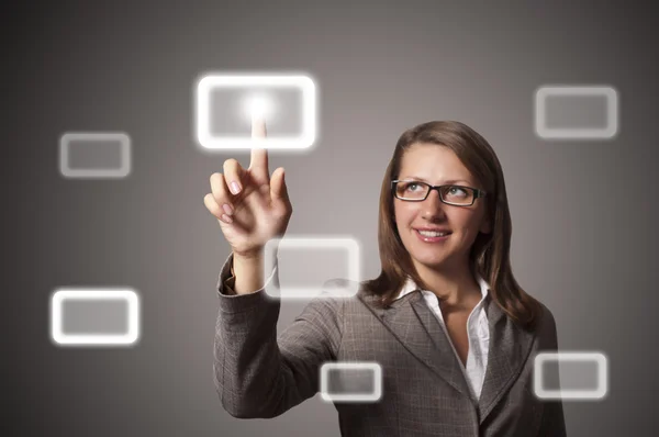 Young business woman presses a button touch — Stock Photo, Image