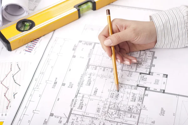 Pencil, hand, blueprints on desktop — Stock Photo, Image
