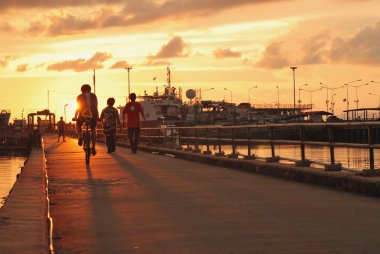 Boy on bike sunset clipart