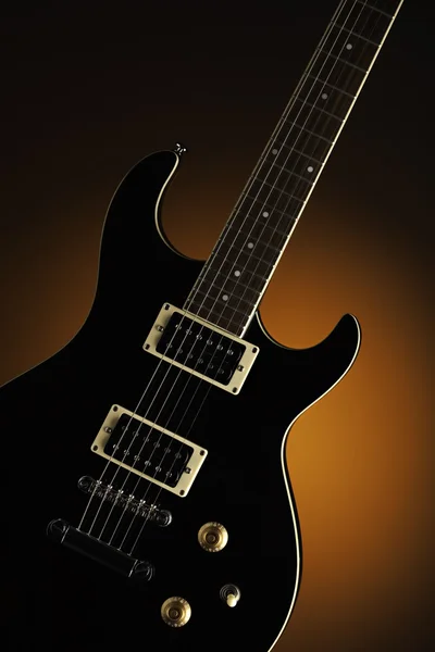 Guitarra eléctrica negra en naranja —  Fotos de Stock