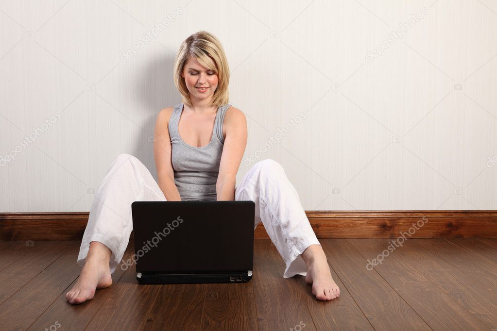 Beautiful woman social networking with her laptop