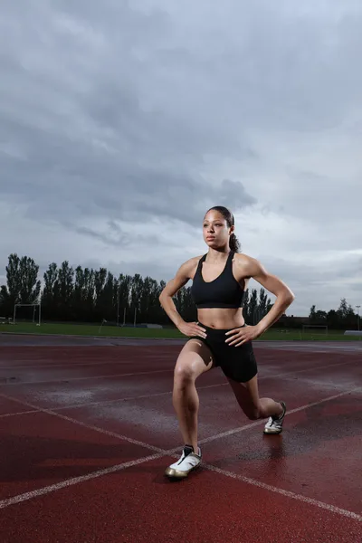 stock image Lunge exercise for quadriceps by athlete on track