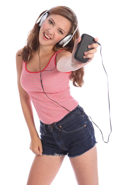 Teenage girl dances to music from mobile phone — Stock Photo, Image