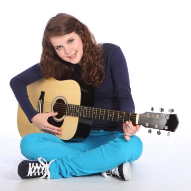 Cute smile by teenager girl on acoustic guitar clipart