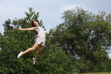 High jump in trees for success of beautiful girl clipart