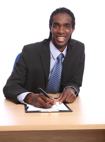 stock image African American businessman signing document