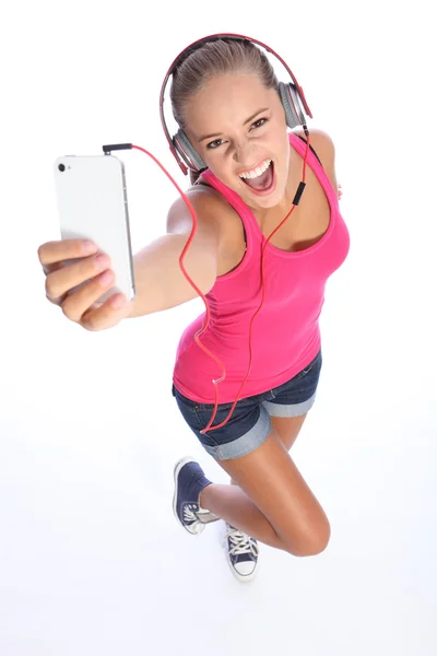 Happy sexy teenage girl has music fun with phone — Stock Photo, Image