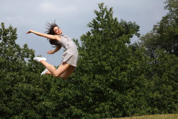 Beautiful sexy woman flying jump for fun success — Stock Photo, Image