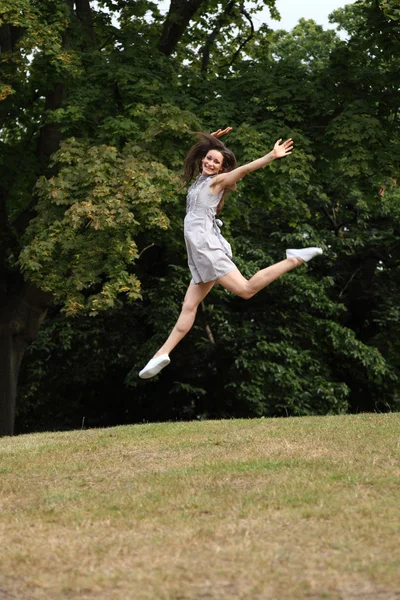 Jump for joy beautiful girl in countryside leaping — Stock Photo, Image