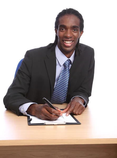 African American businessman signing document Stock Picture