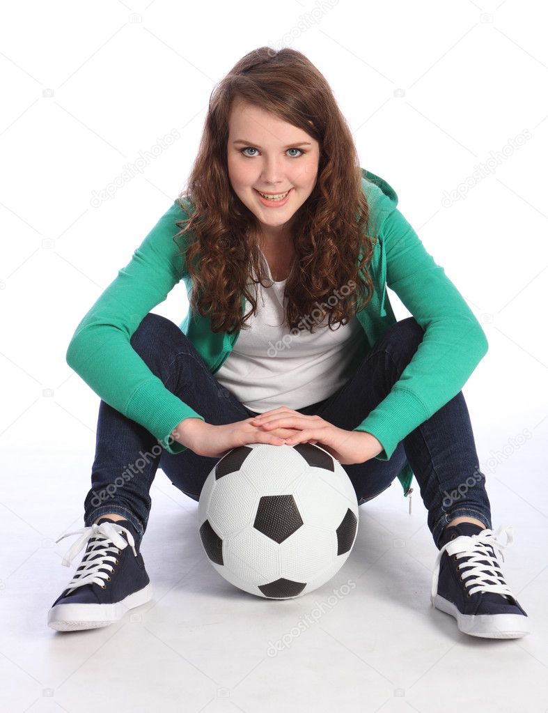Teenage girl soccer player sits with football